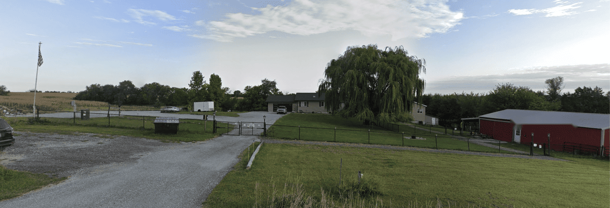 Kawa Farms entrance gate, flagpole, and red barn