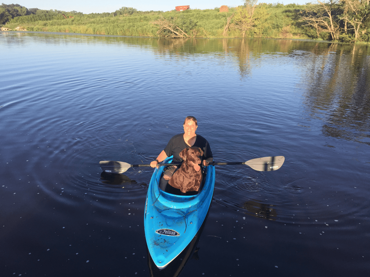 Dog kayaking with owner on the water